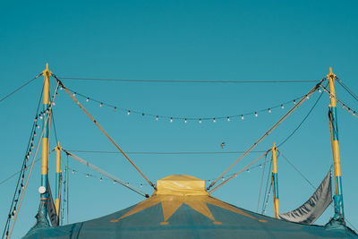 Low angle view of cables against clear blue sky