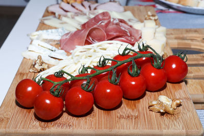 Close-up of tomatoes and vegetables on cutting board