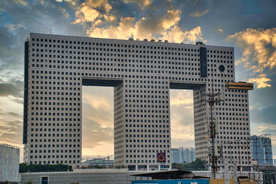 Low angle view of buildings against sky during sunset