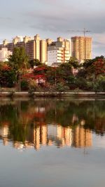 Reflection of buildings in lake against sky