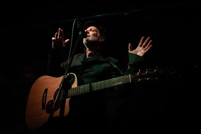 Man playing guitar in the dark