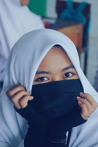 Close-up portrait of young woman wearing hijab