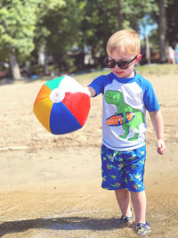 Portrait of boy playing with umbrella
