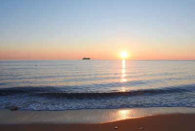 Scenic view of sea against clear sky during sunset