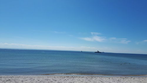 Scenic view of sea against blue sky