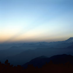 Scenic view of mountain range at sunset