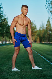 Low section of man standing on field