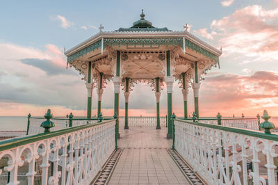 Empty gazebo at brighton pier against sky during sunset