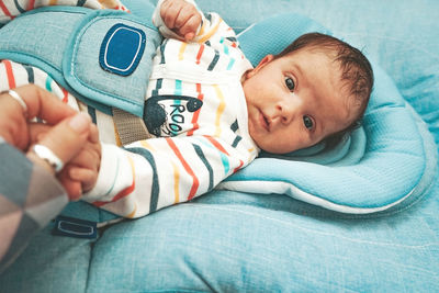 Portrait of cute baby lying on bed