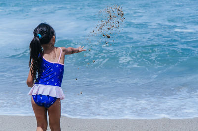 Full length of woman standing at beach