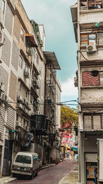 Street amidst buildings in city against sky