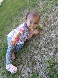 Portrait of cute girl on field