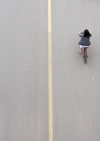 High angle view of woman riding bicycle on street