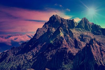 Scenic view of mountains against cloudy sky