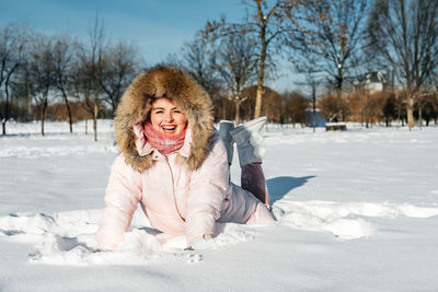 Portrait of smiling woman in snow