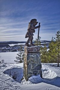 Statue against sky during winter