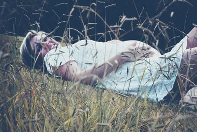 Woman lying on field
