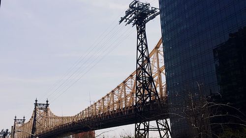 Low angle view of power lines against sky