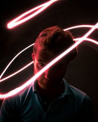Portrait of man with light painting at night