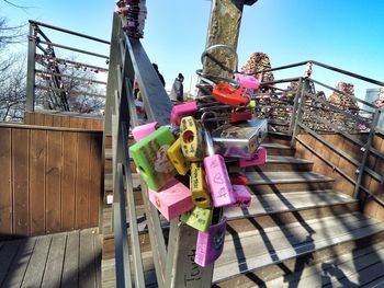 Close-up of padlocks on railing against sky
