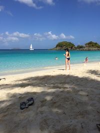 People at beach against sky