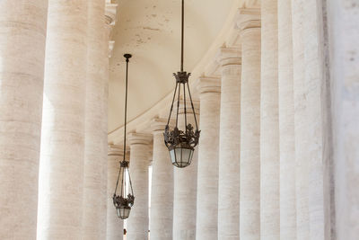 Low angle view of illuminated chandelier hanging in building