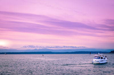 Sailboat sailing on sea against sky during sunset