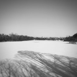 Scenic view of frozen lake against clear sky