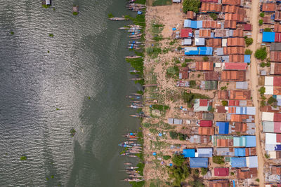 Aerial view of houses by sea in town