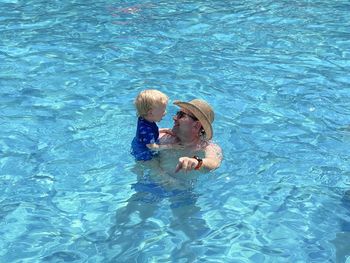 High angle view of woman swimming in pool