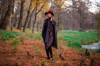 Young woman standing in forest