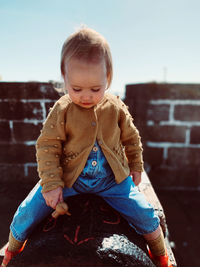 Cute girl sitting outdoors