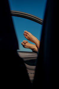 Close-up of hand against window