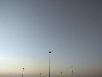 Low angle view of silhouette street light against sky