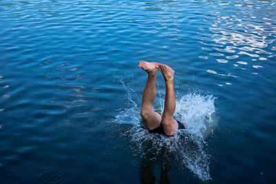 High angle view of man jumping in sea