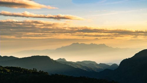 Scenic view of silhouette mountains against sky during sunset