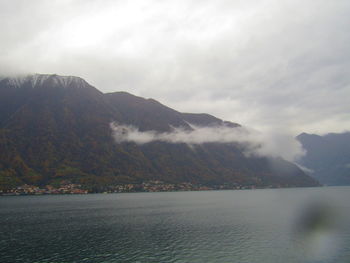 Scenic view of sea and mountains against sky
