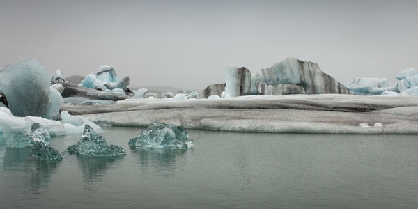 Scenic view of lake against clear sky during winter