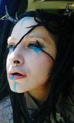 Close-up portrait of young woman looking away