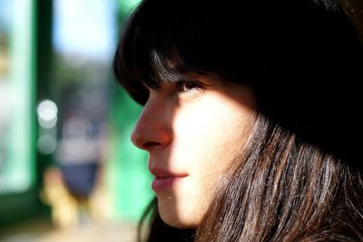 Close-up of thoughtful woman looking away at home