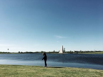 Full length of woman standing on shore