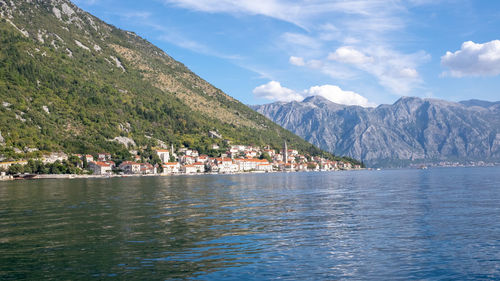 Scenic view of lake by mountain against sky