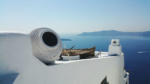 Cropped built structure against calm blue sea