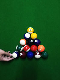 Cropped hand of person with cue ball on table