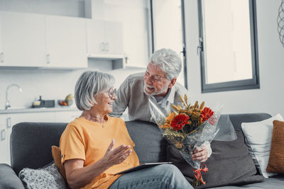 Portrait of senior couple sitting at home
