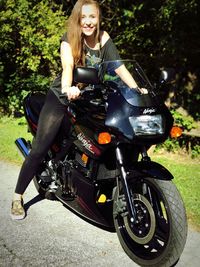 Portrait of young woman riding motorcycle