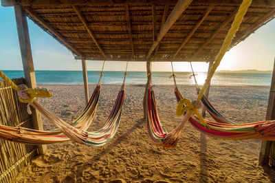 Hammocks under thatched roof at beach