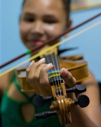 Close-up of boy playing guitar