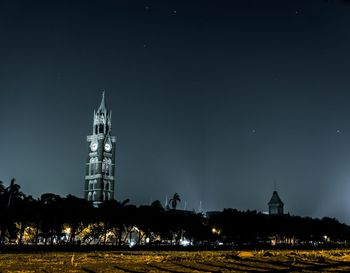 Illuminated city against sky at night