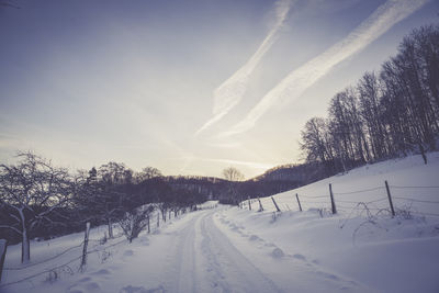 Snow covered landscape against sky